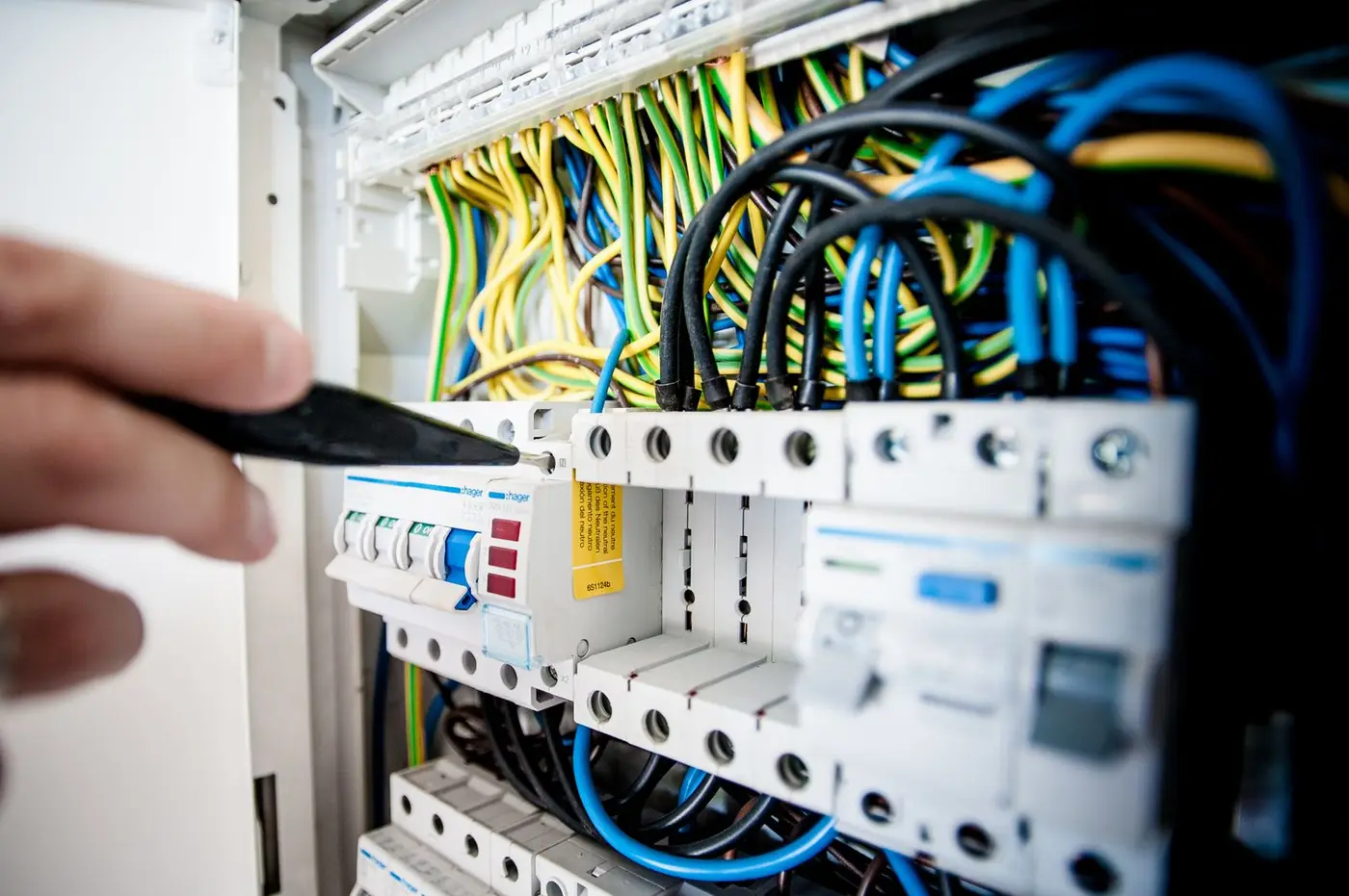 Open electrical breaker panel with color-coded wiring